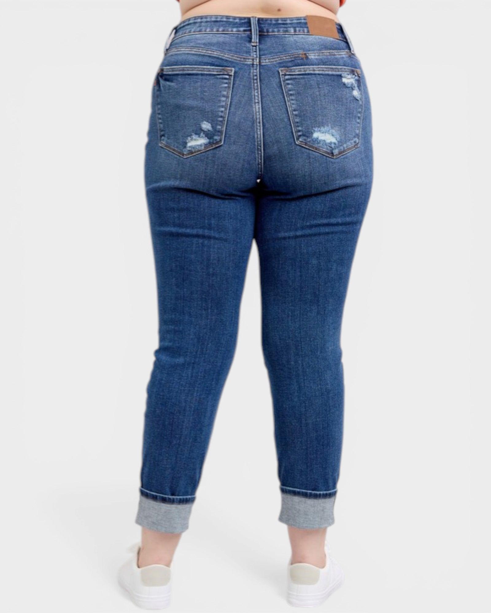 Blue jeans worn by a person on a white background
