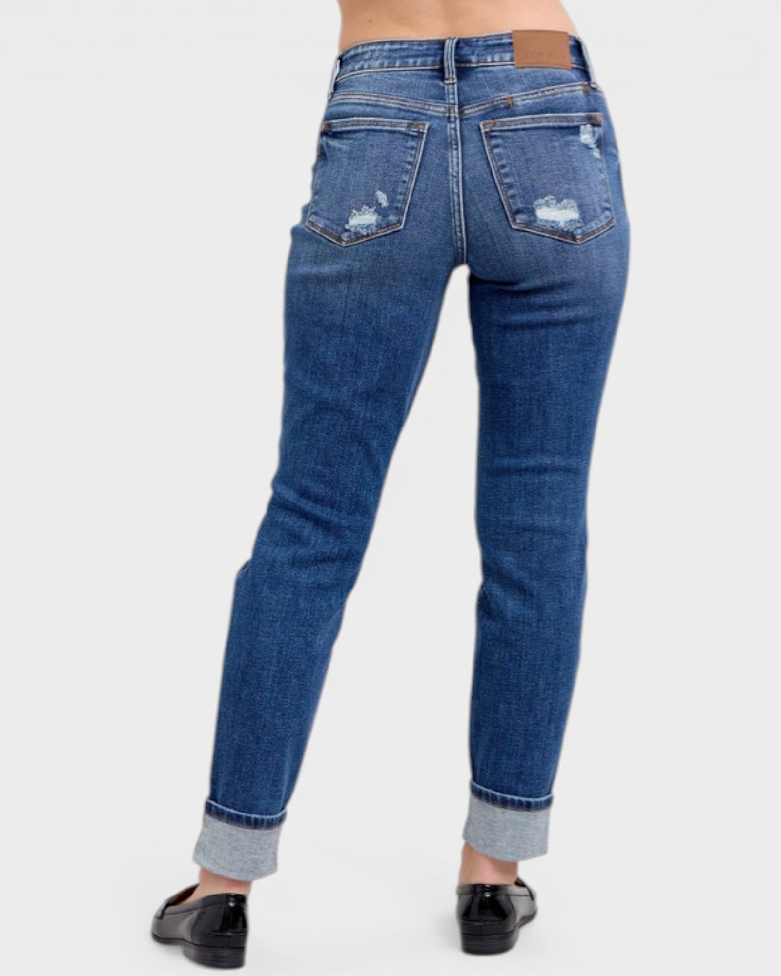 Blue jeans with a distressed look on a white background