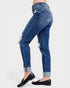 Blue jeans with distressed details worn by a person on a white background