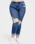 Blue distressed jeans worn by a person on a white background
