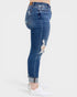 Blue distressed jeans worn by a person on a white background