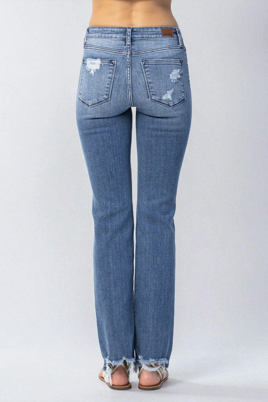 Blue jeans with distressed details on a white background
