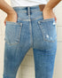 Close-up of blue jeans with a white background