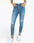 A person wearing light blue distressed skinny jeans with cuffed hems and ripped details on the thighs, paired with a white top and white sneakers, against a plain white background.