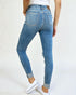 Blue jeans worn by a person on a white background