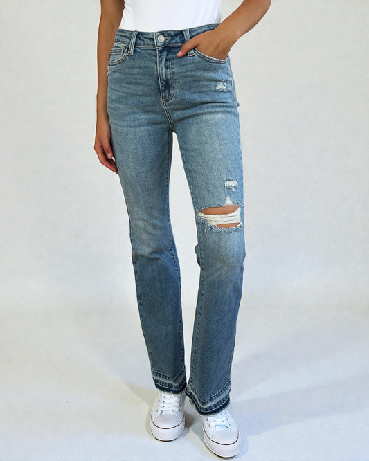 Person wearing blue jeans with a white background