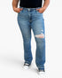 A person wearing medium-wash blue distressed jeans with a ripped knee detail, paired with a black top and black-and-white sneakers, shown against a plain light gray studio background.