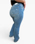 A person wearing blue denim flare jeans, shown from the back and side against a plain white studio background.