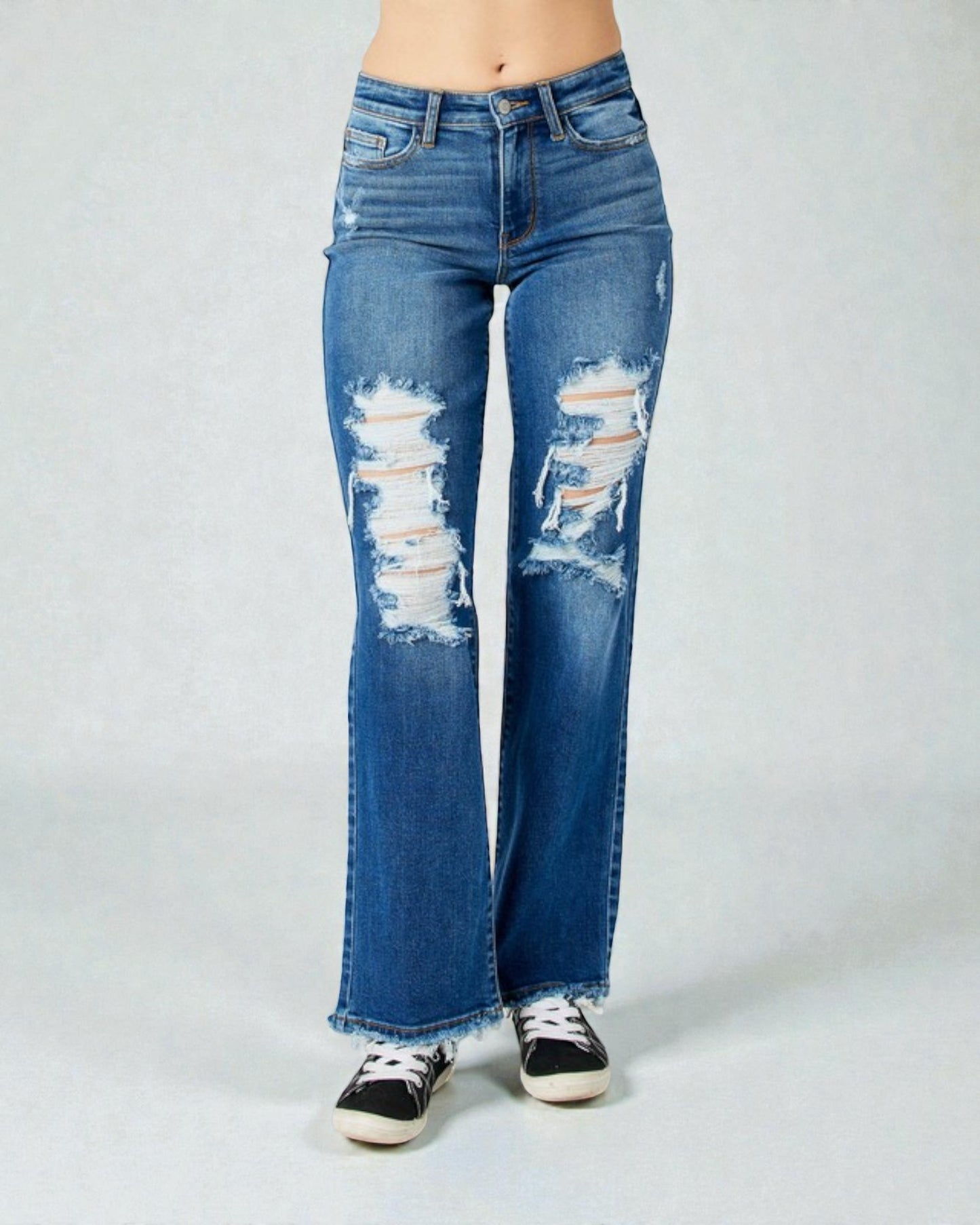 Distressed blue jeans on a white background