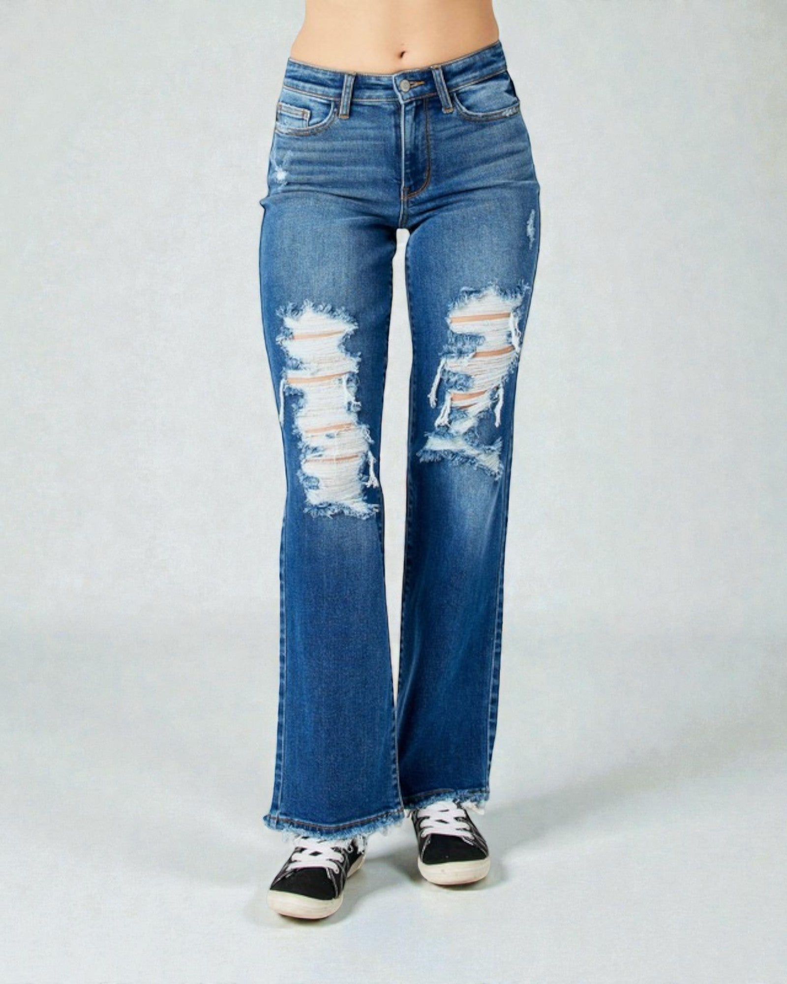Distressed blue jeans on a white background