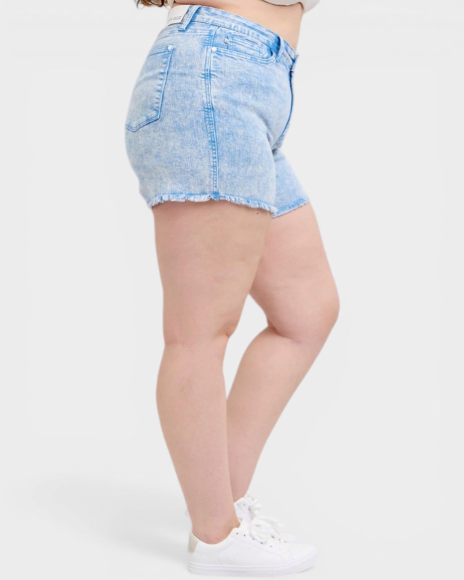 Light blue denim shorts worn by a person on a white background