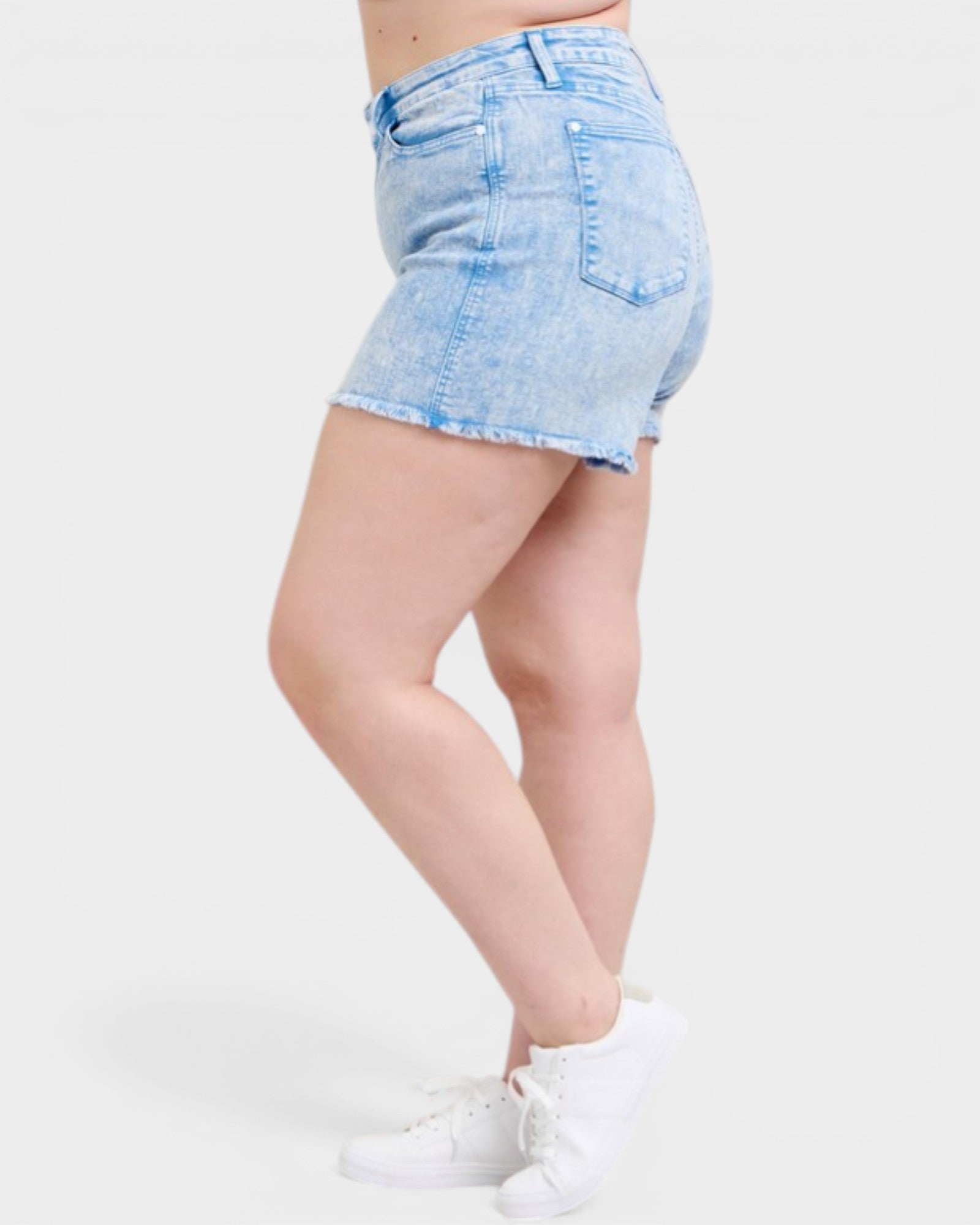 Light blue denim shorts worn by a person on a white background