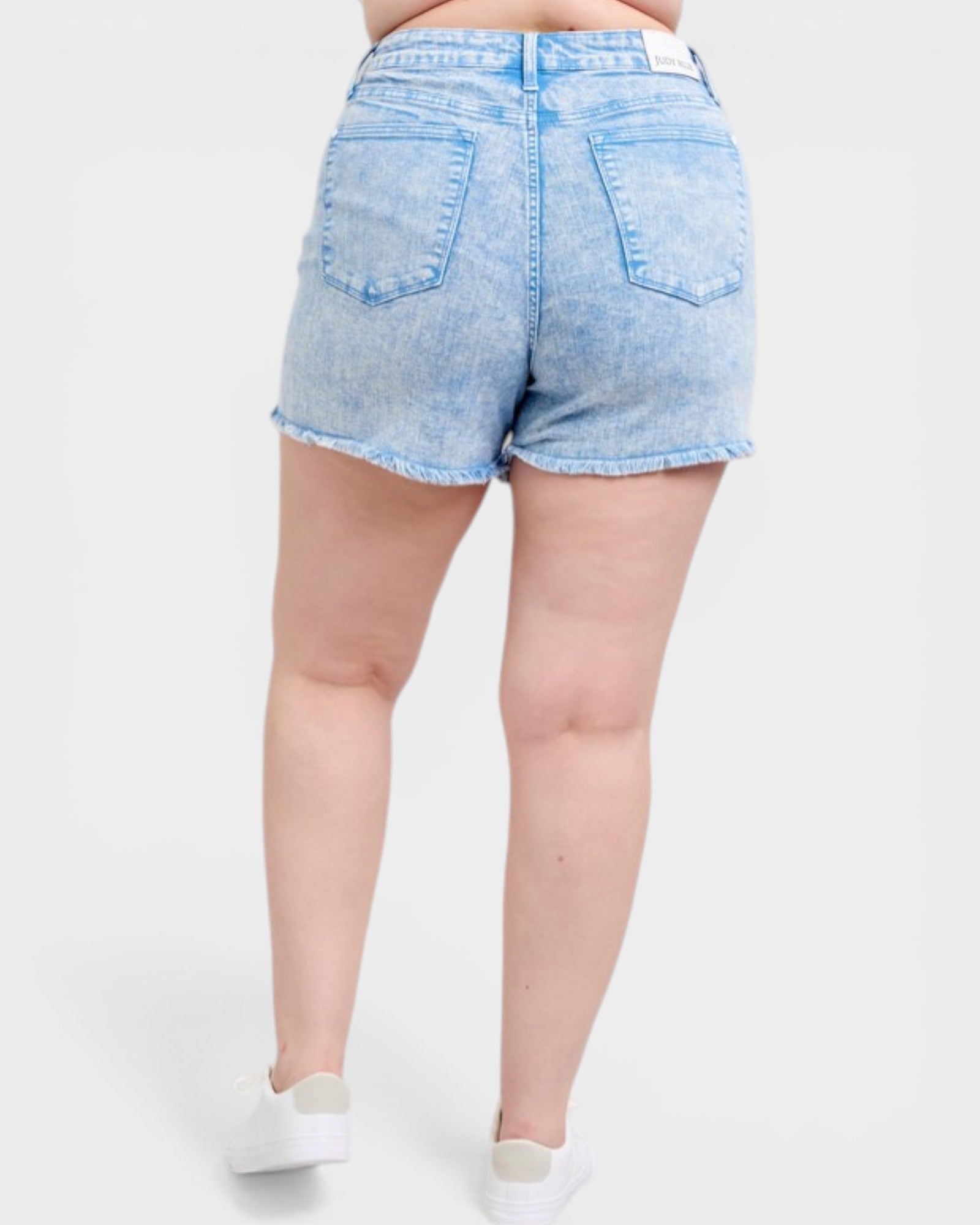 Light blue denim shorts worn by a person on a white background