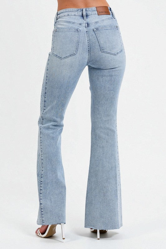 Light blue flared jeans on a white background
