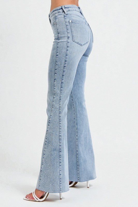 Light blue flared jeans on a white background