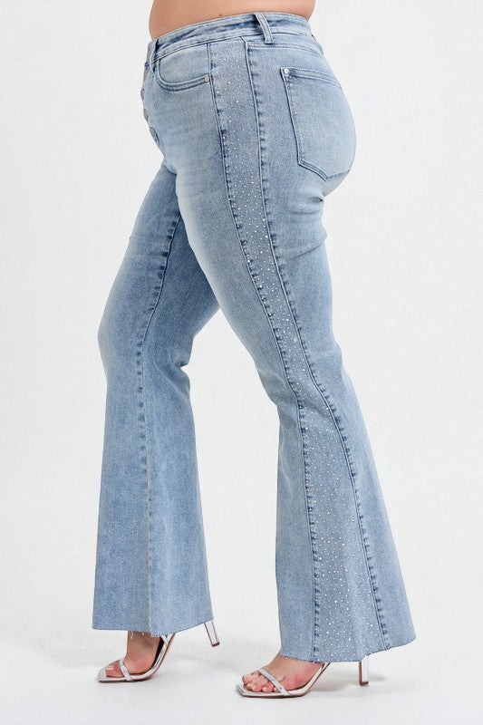 Light blue flared jeans worn by a person on a white background