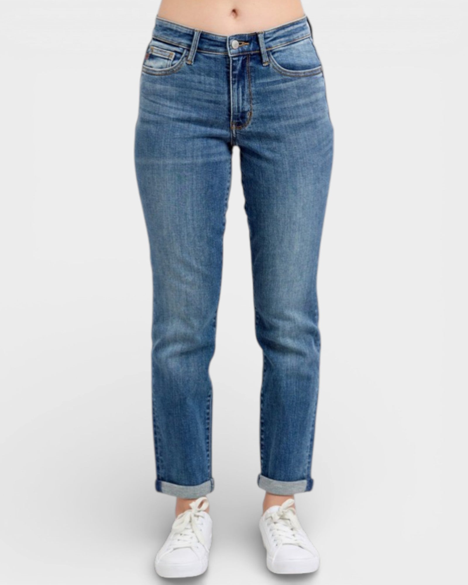 Blue jeans worn by a person on a white background