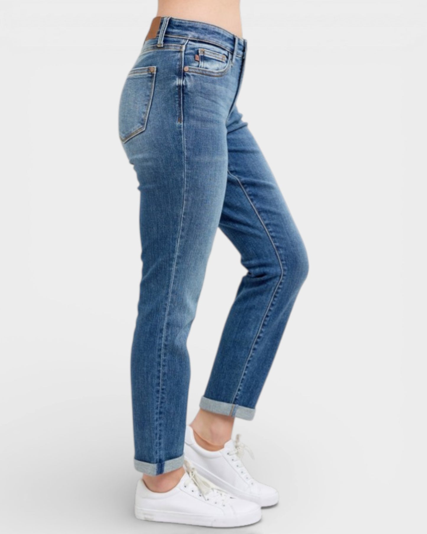 Blue jeans worn by a person on a white background