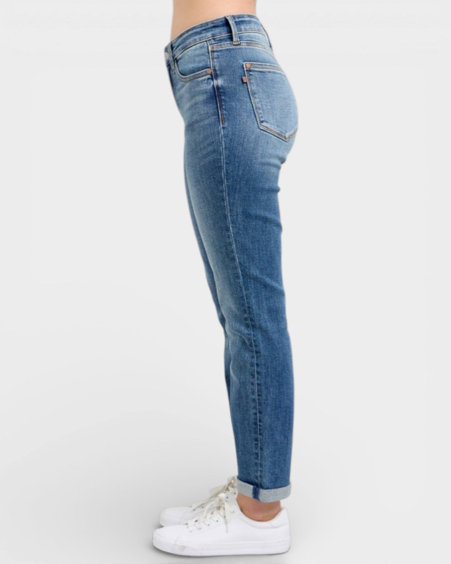 Blue jeans worn by a person on a white background