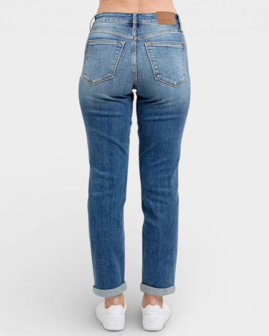 Blue jeans worn by a person on a white background