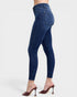 Blue jeans worn by a person on a white background