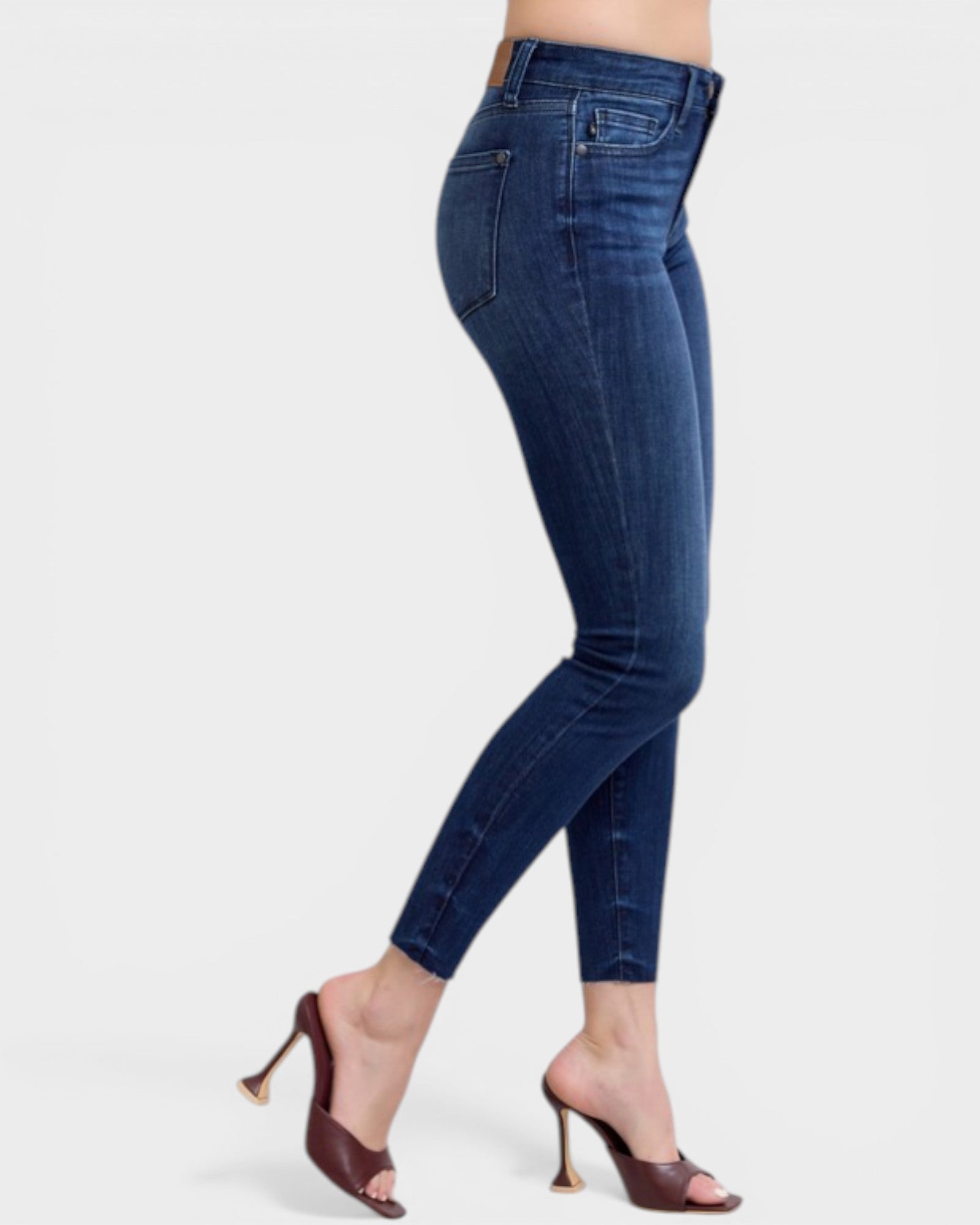 Blue jeans worn by a person on a white background