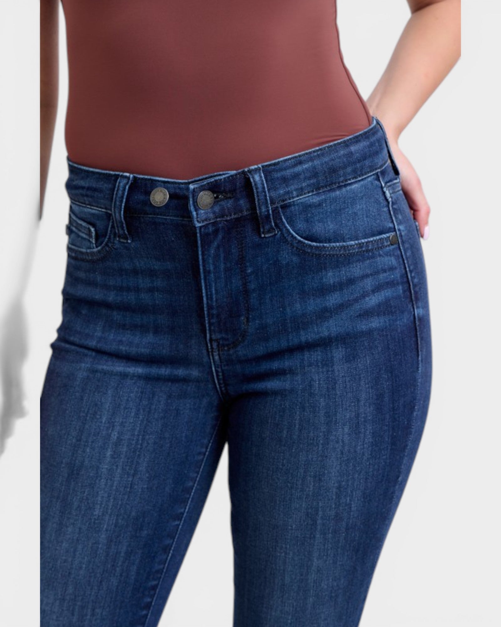 Blue jeans worn by a person on a white background