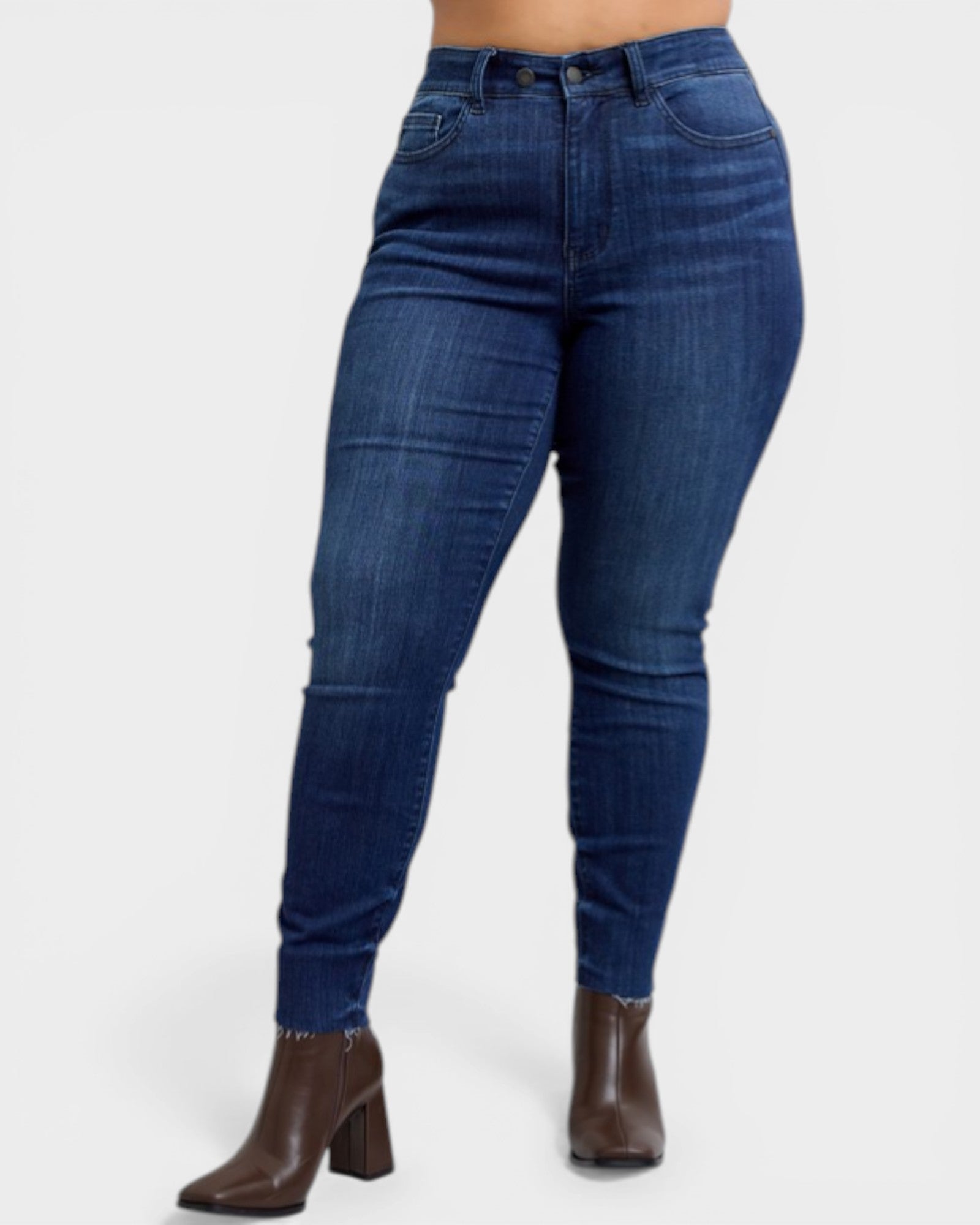 Blue jeans worn by a person on a white background