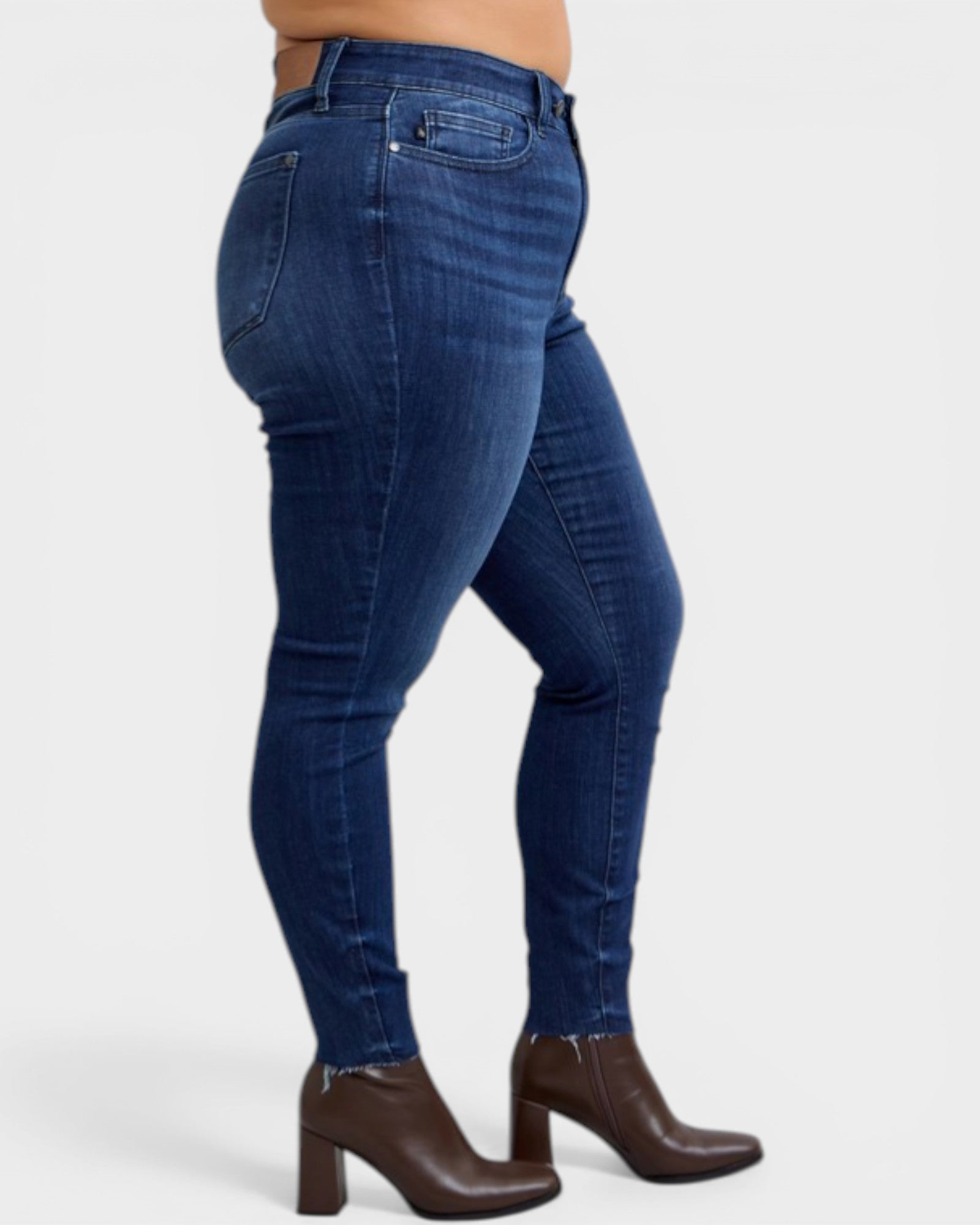 Blue jeans worn by a person on a white background