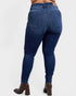 Blue jeans worn by a person on a white background