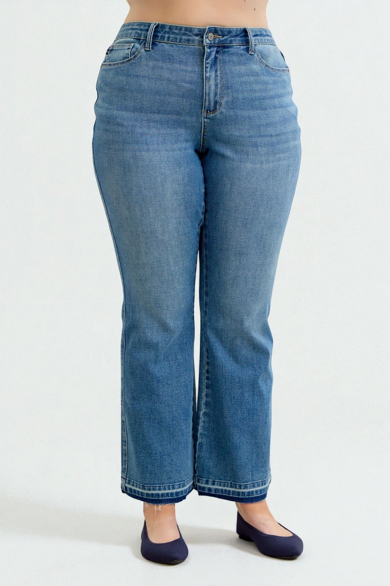 Blue jeans worn by a person on a white background