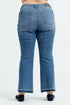 Blue jeans worn by a person on a white background