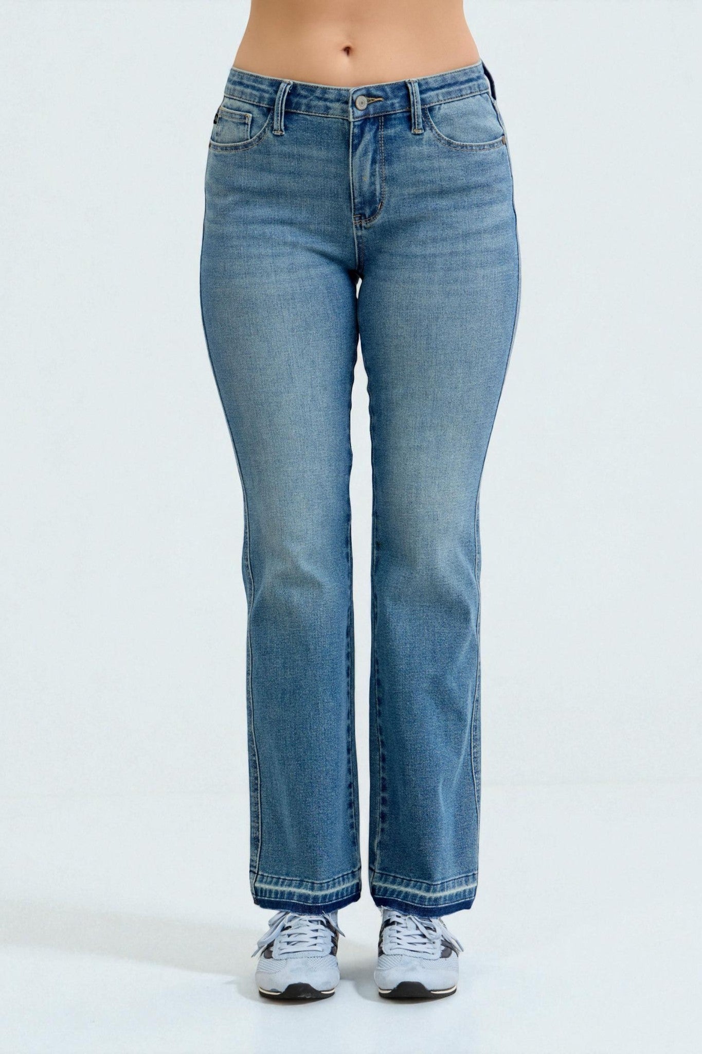 Blue jeans worn by a person on a white background