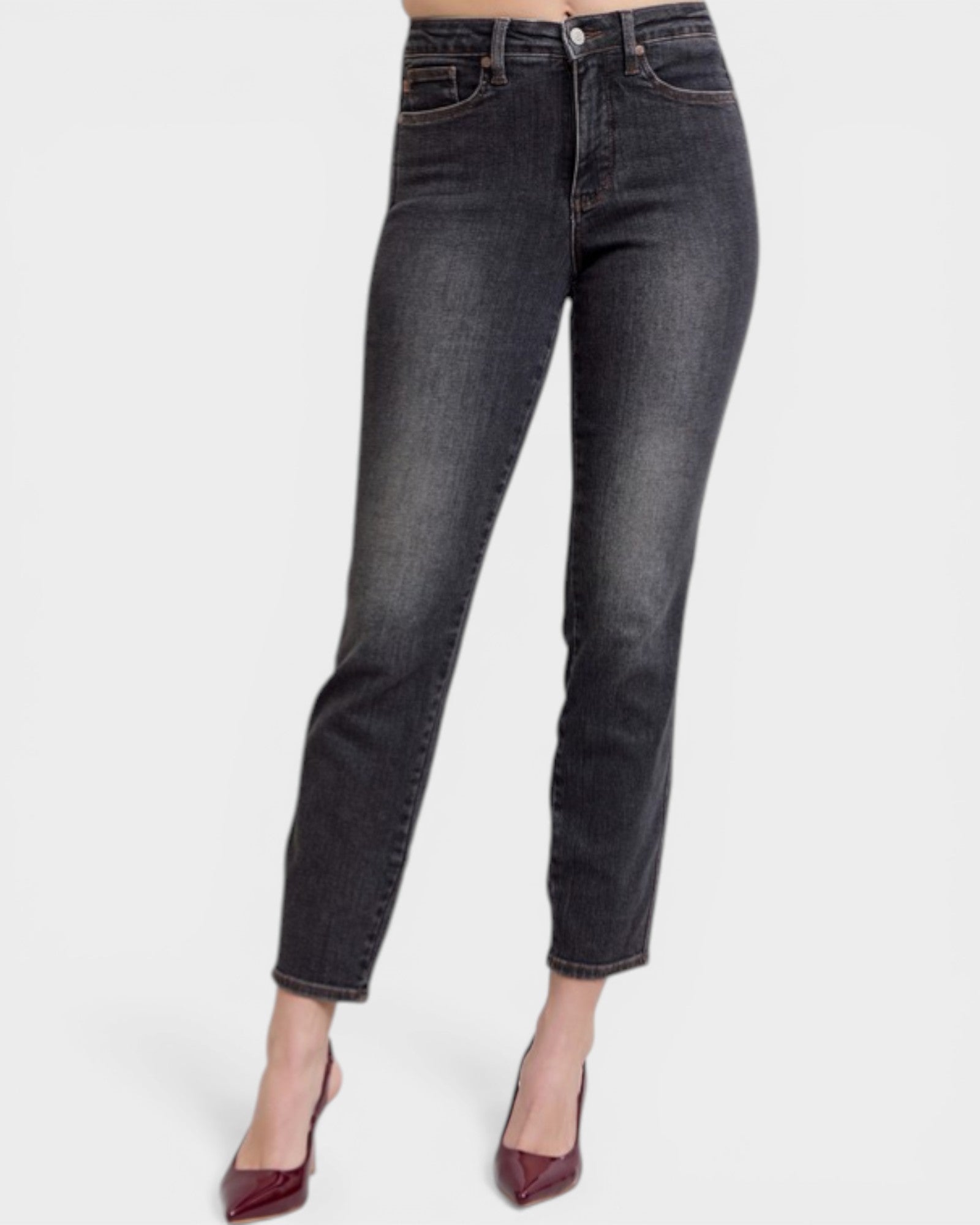 Black jeans worn by a person on a white background