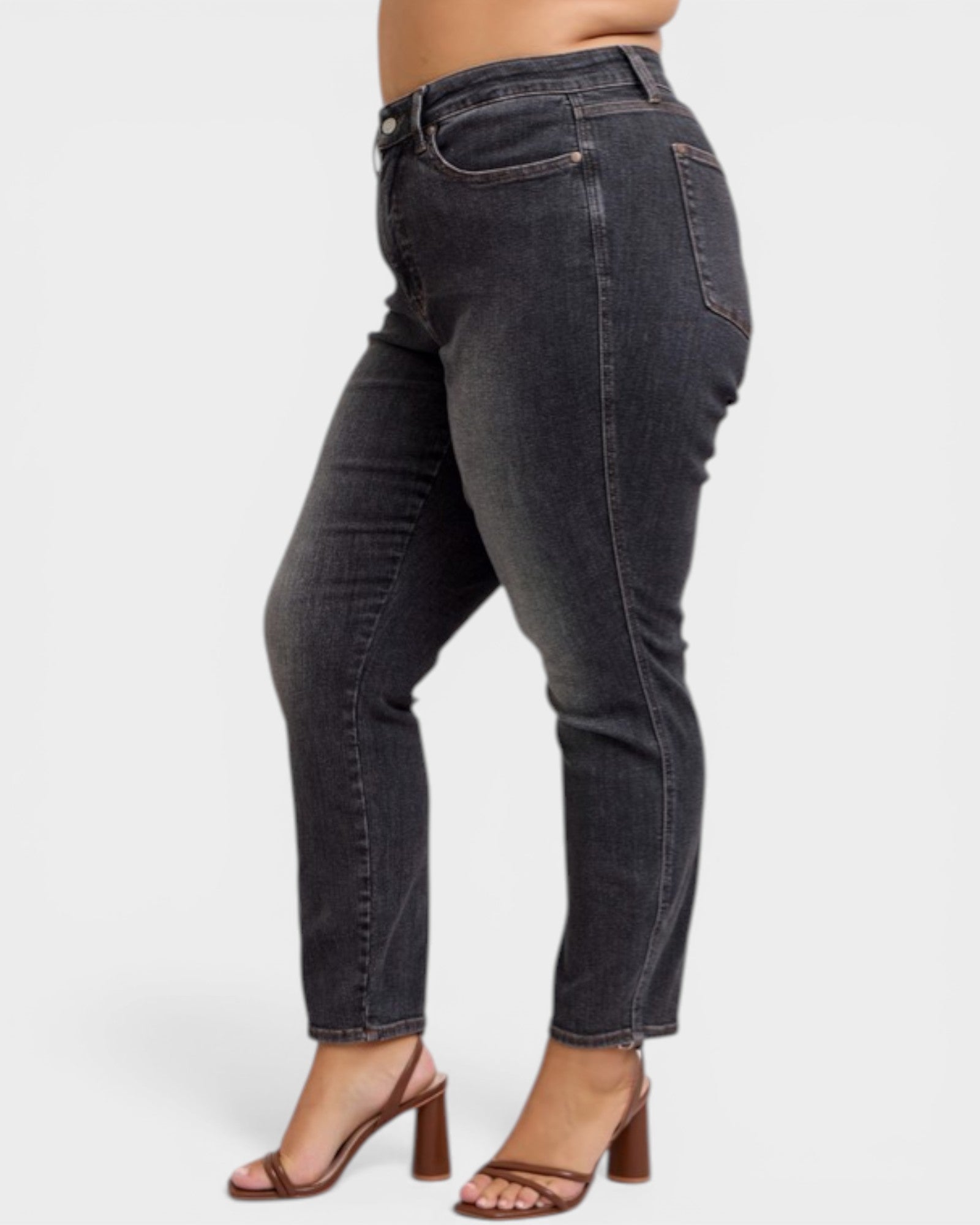 Black jeans worn by a person on a white background
