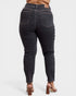 Black jeans worn by a person on a white background