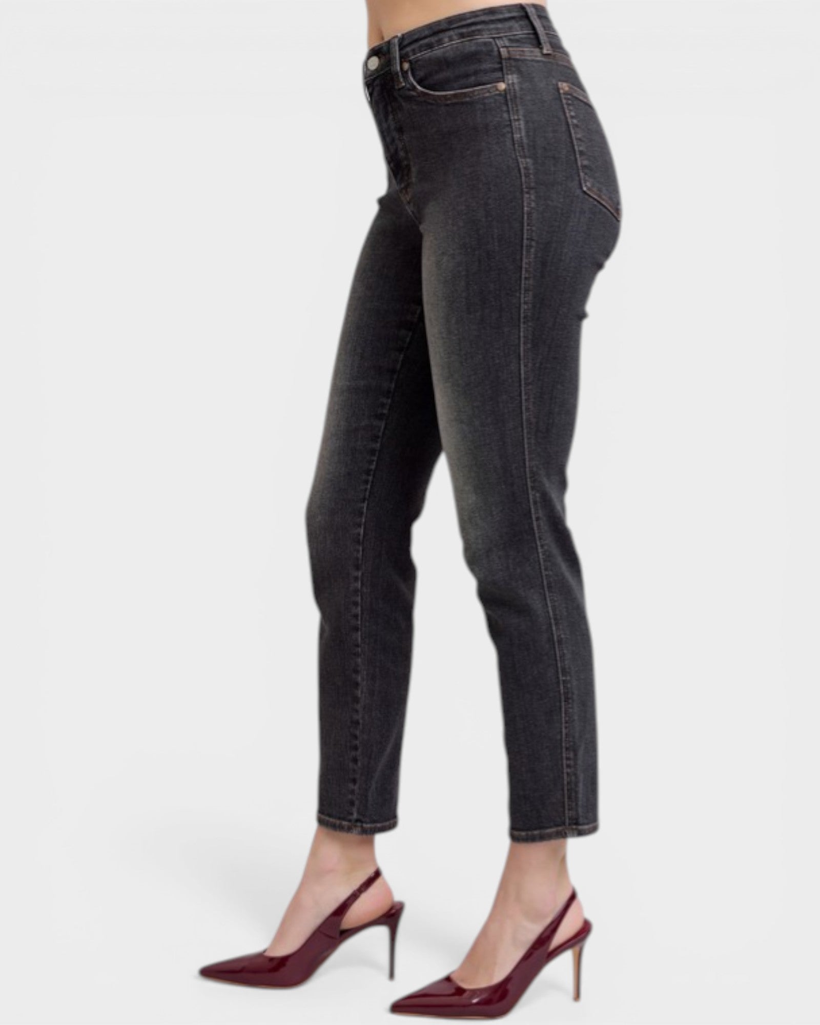 Black jeans worn by a person on a white background