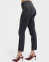 Black jeans worn by a person on a white background