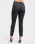 Dark blue jeans worn by a person on a white background