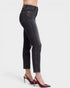 Black jeans worn by a person on a white background
