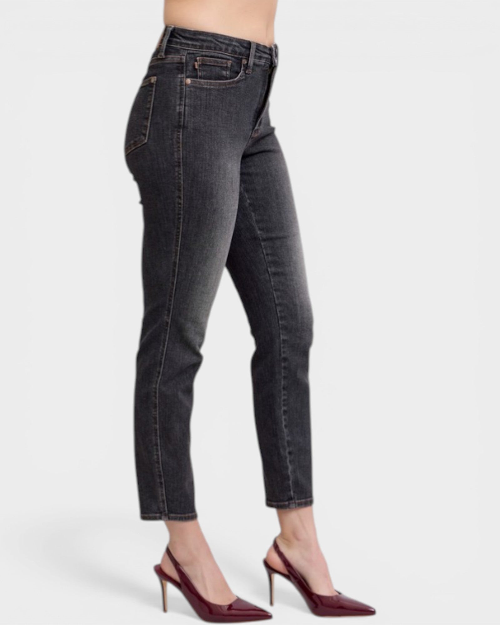 Black jeans worn by a person on a white background