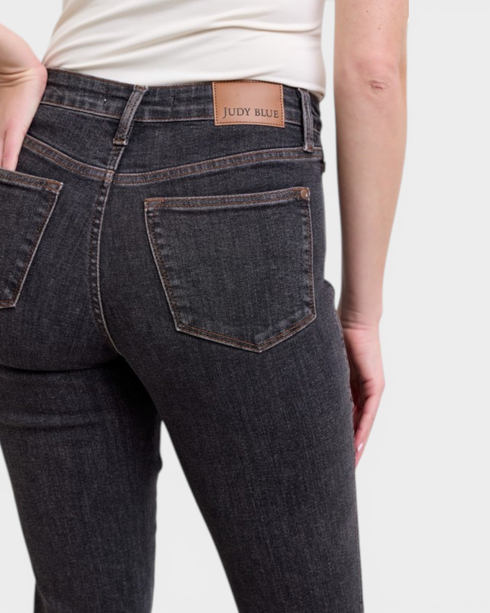 Dark blue jeans with a visible brand label on a plain background