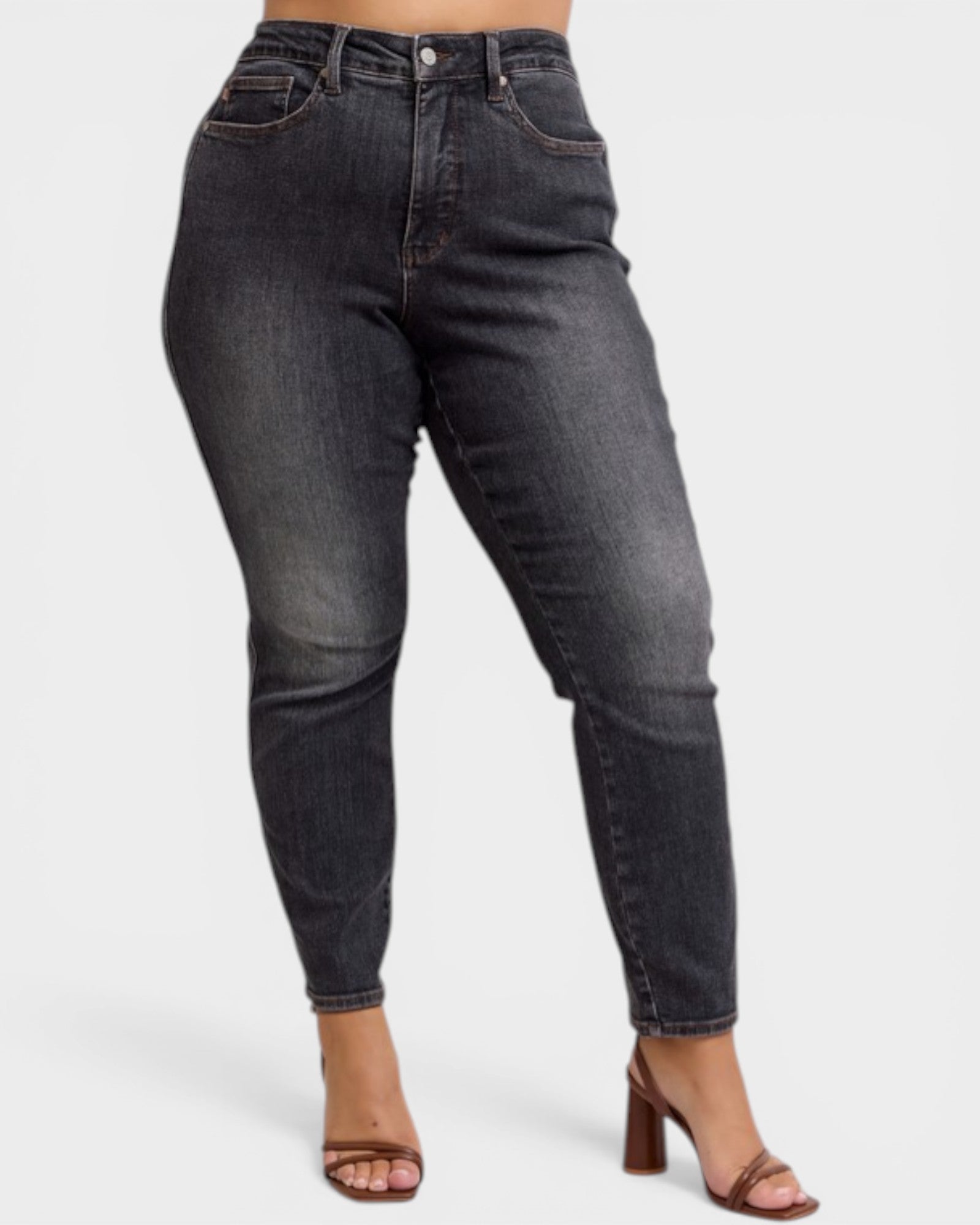Black jeans worn by a person on a white background