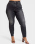 Black jeans worn by a person on a white background