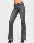Black flared jeans worn by a person on a white background