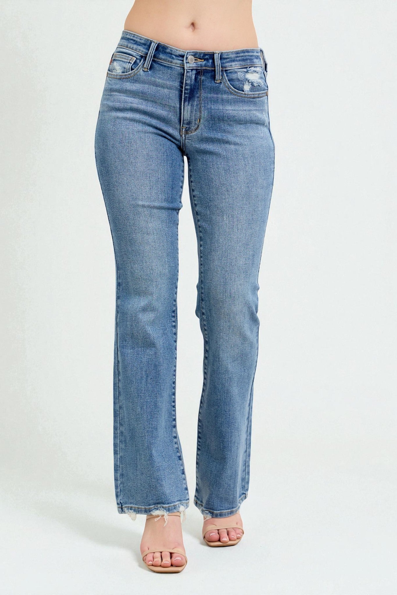 Blue jeans worn by a person on a white background