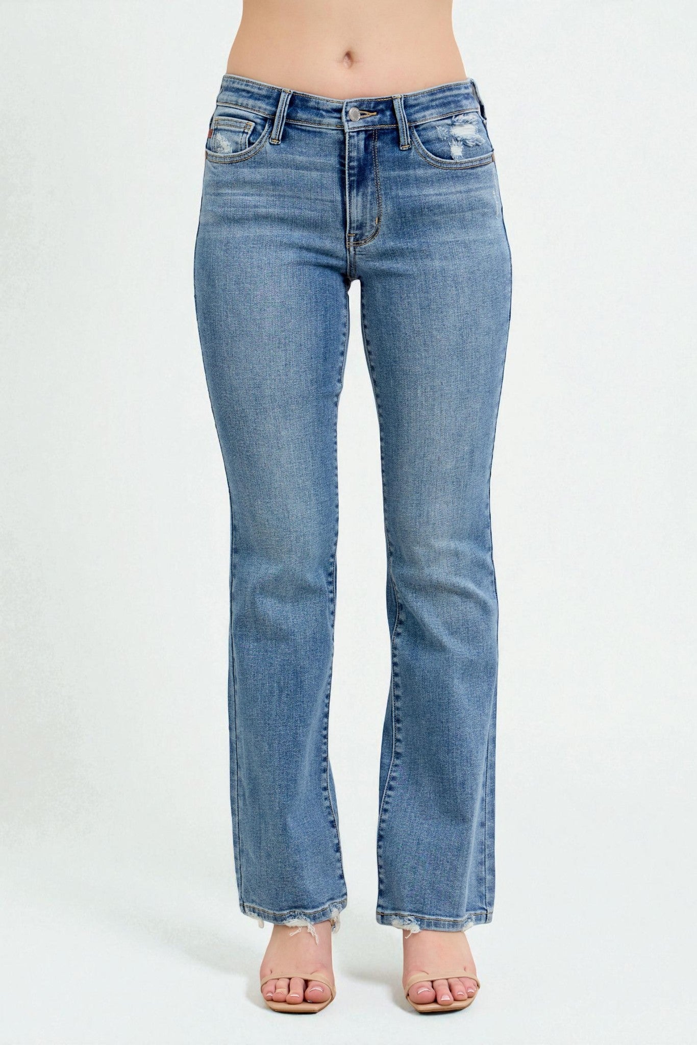 Blue jeans worn by a person on a white background