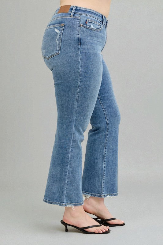 Light blue jeans worn by a person on a gray background