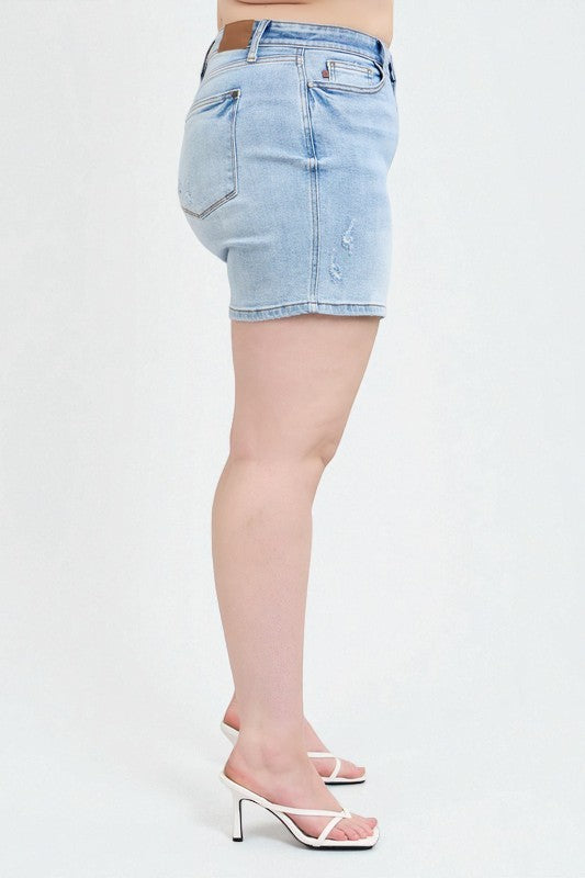Light blue denim shorts worn by a person on a white background