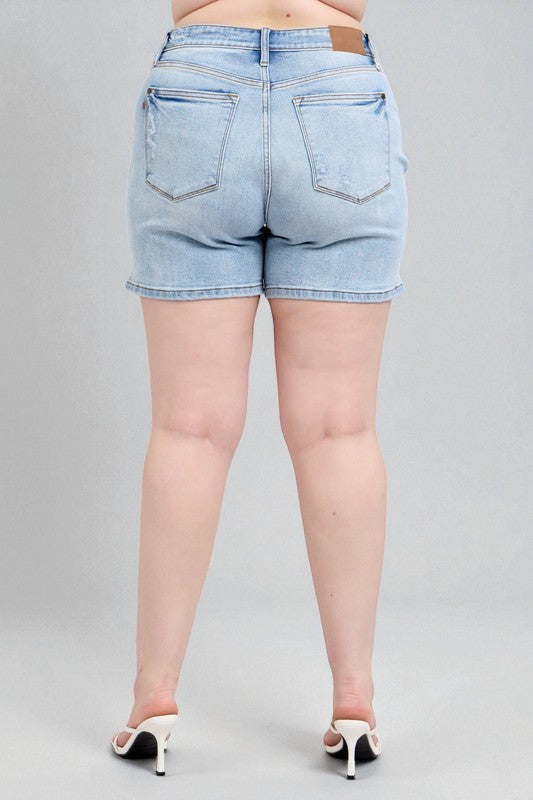 Light blue denim shorts worn by a person on a gray background